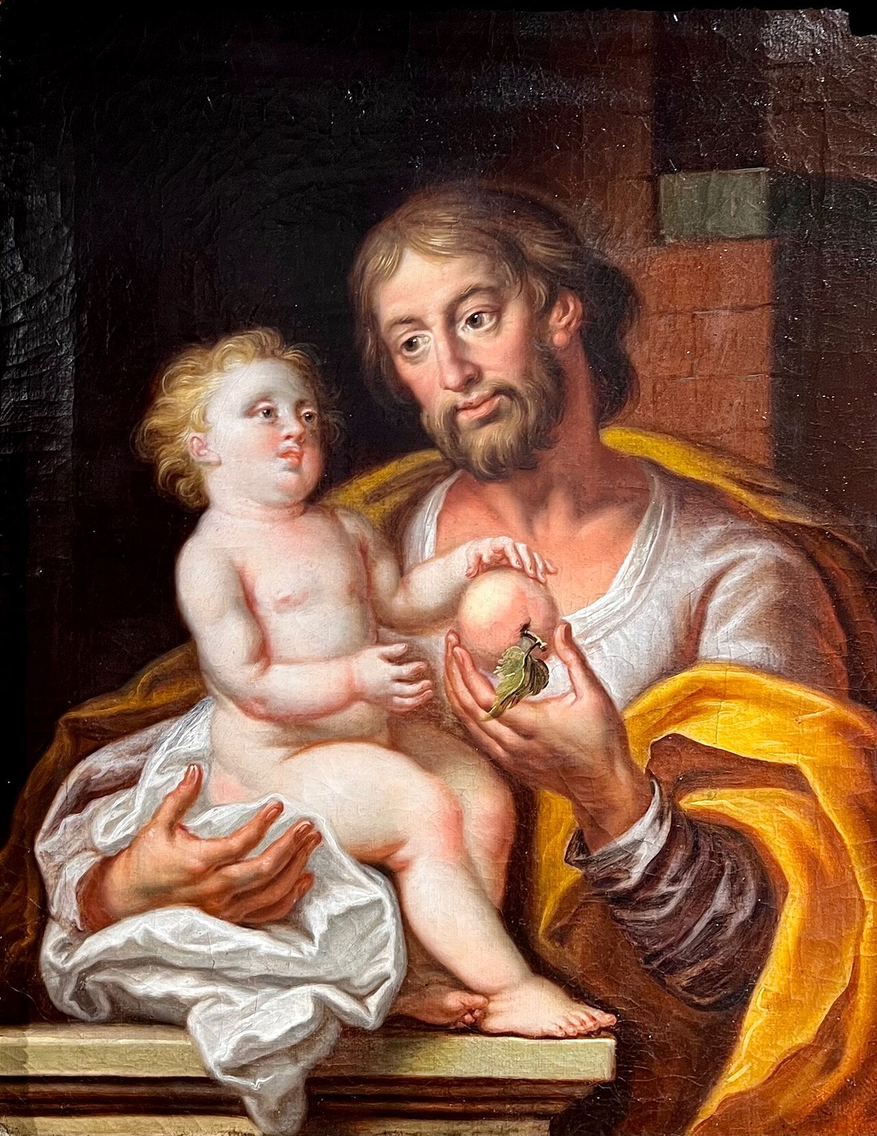 Pintura que representa a San José sosteniendo al Niño Jesús en brazos.